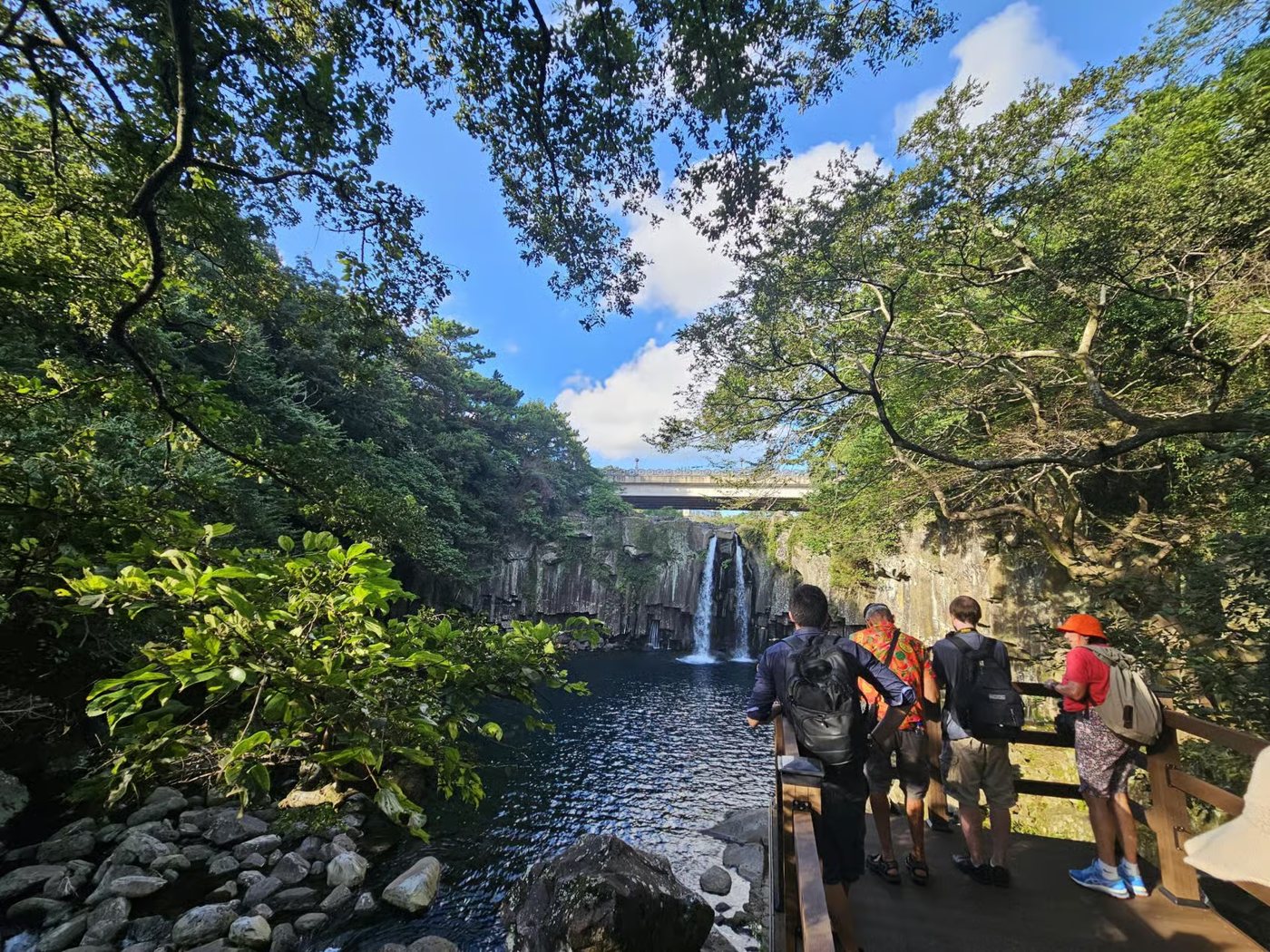 Guests on the viewing deck at Cheonjeyeon Waterfall
