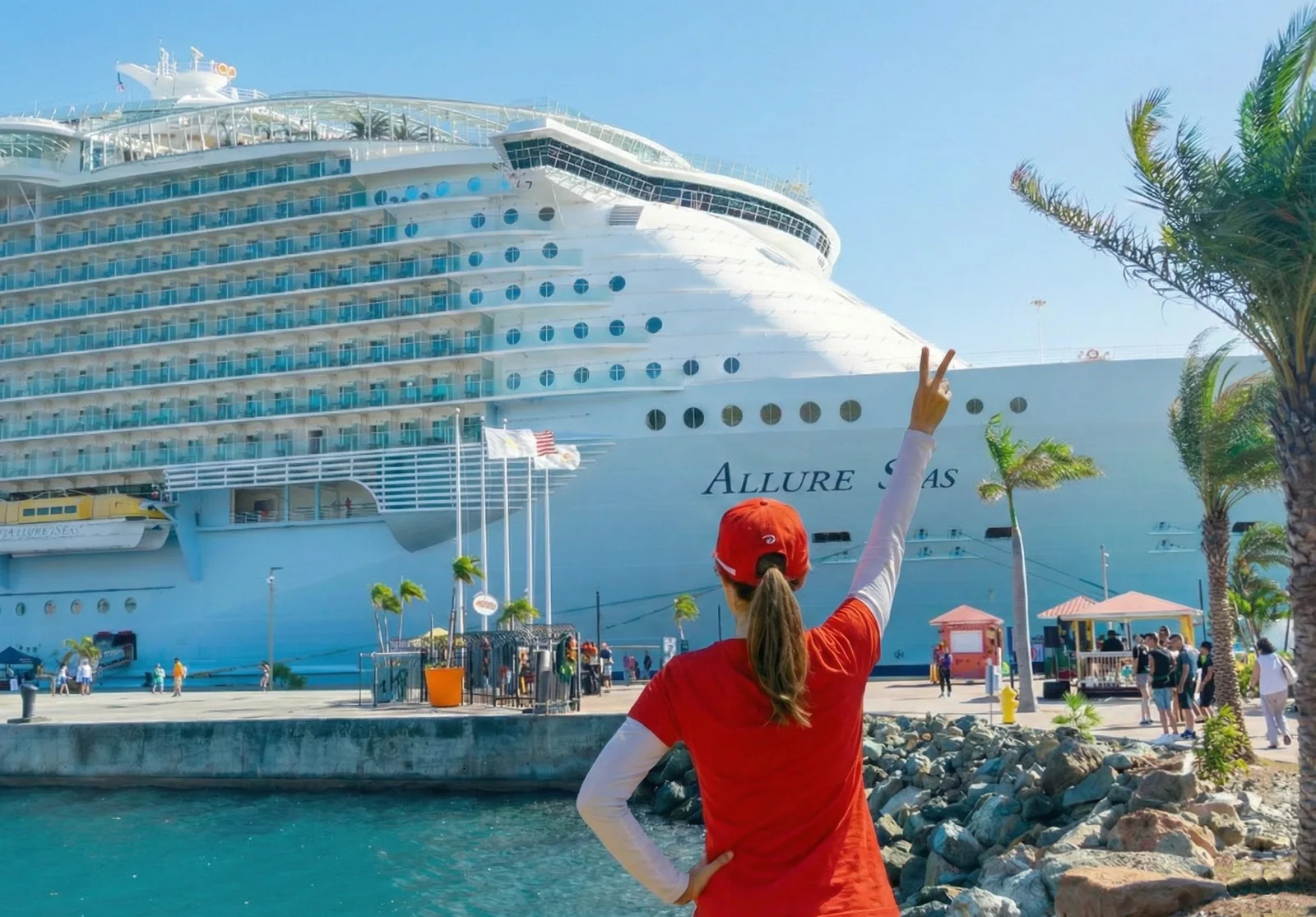 Traveler waving in front of her cruise ship at the port