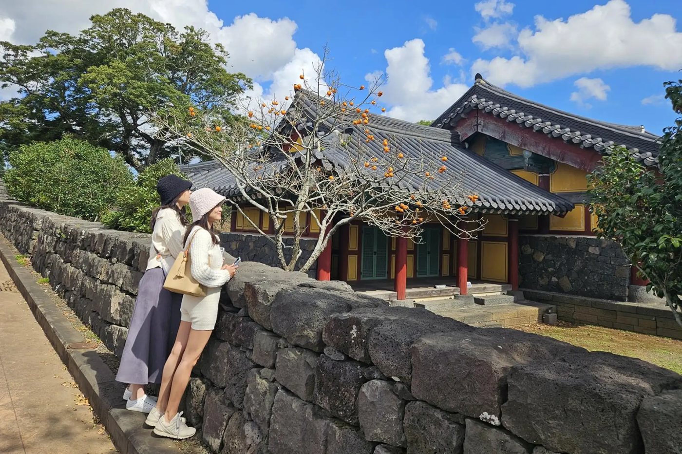 Guests at the stone wall of Yakcheonsa Temple